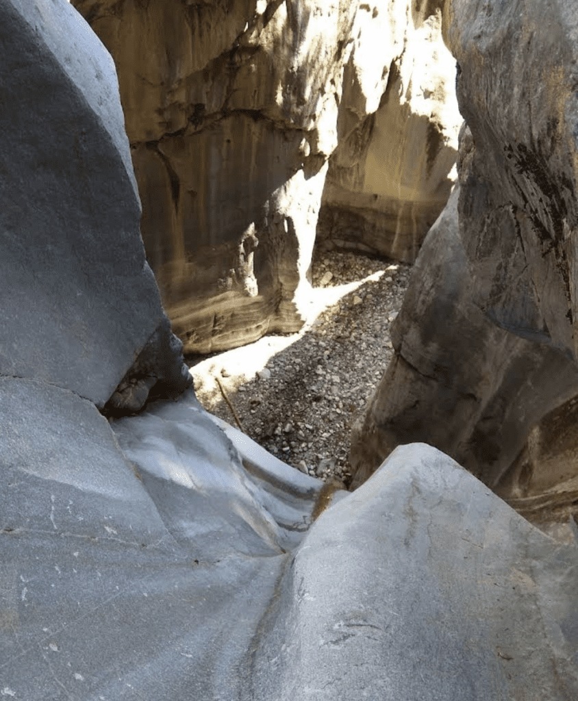 a deep canyon of smooth white stone at Nihahi Creek Trail in Kananaskis, Alberta